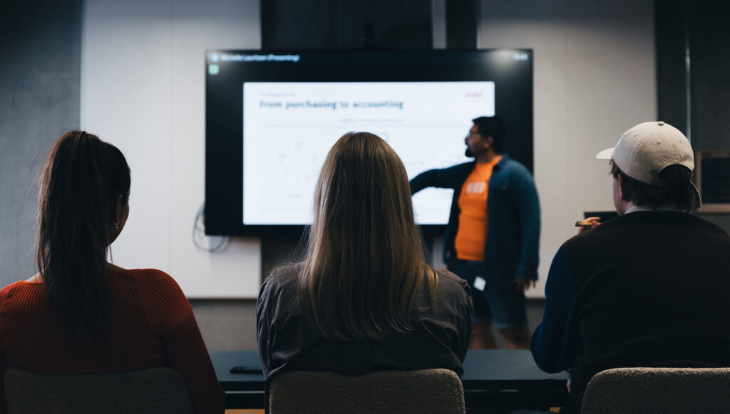 A man presenting in a big screen