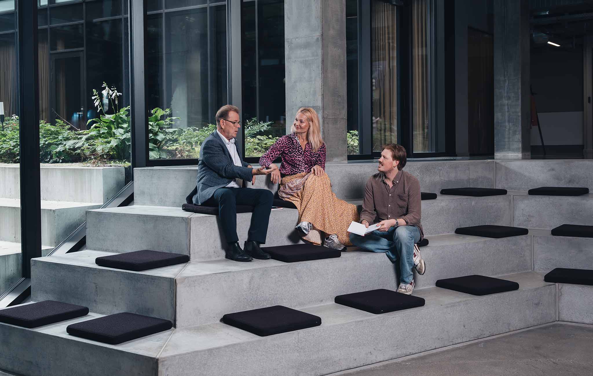 coworkers sitting on stairs and talking